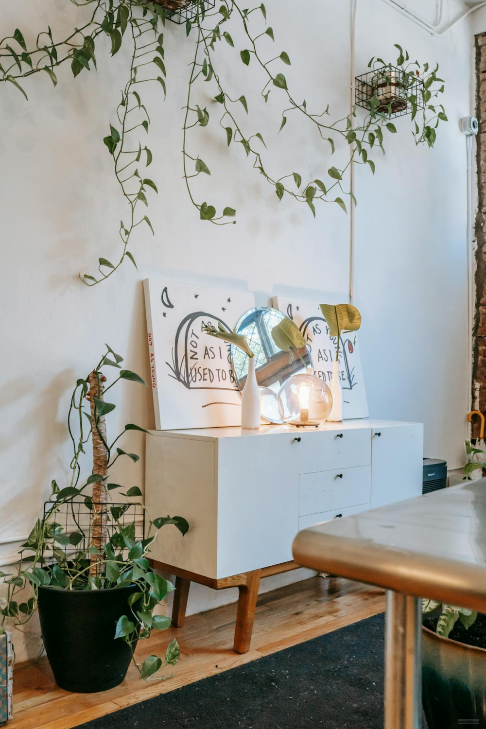 a bedroom with shelves and art